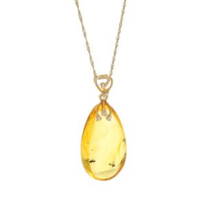 Unique gold amber pendant in the shape of an icicle with an inclusion, decorated with zircons